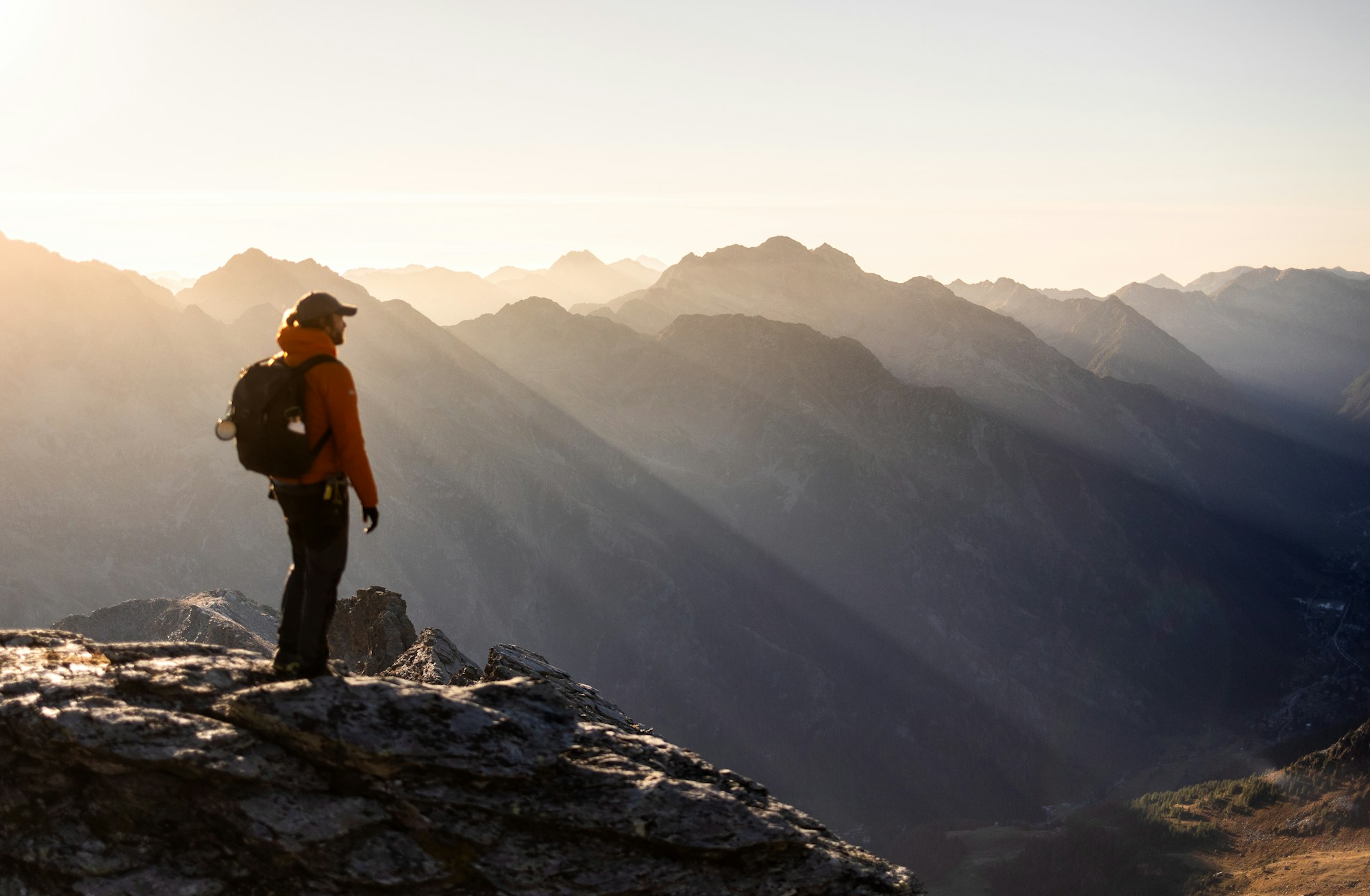 A person looking toward new possibilities from a mountain summit